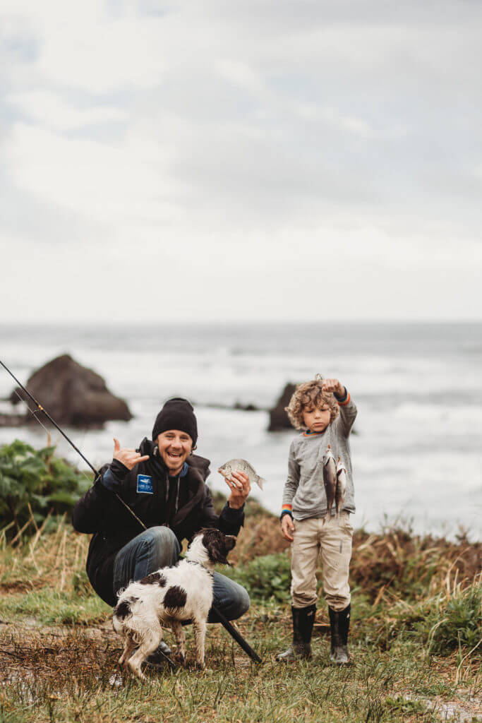 Father, son and dog go fishing on the Oregon coast.