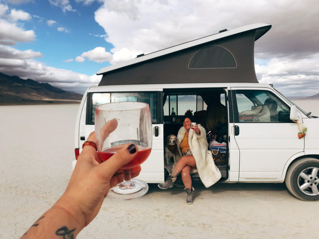 Cheers two women, dog, Alvord Desert, Eurovan Camper