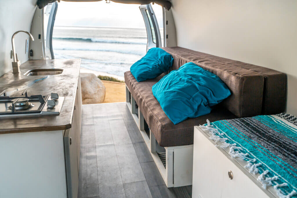 Econoline camper van rental Interior with beach in the background