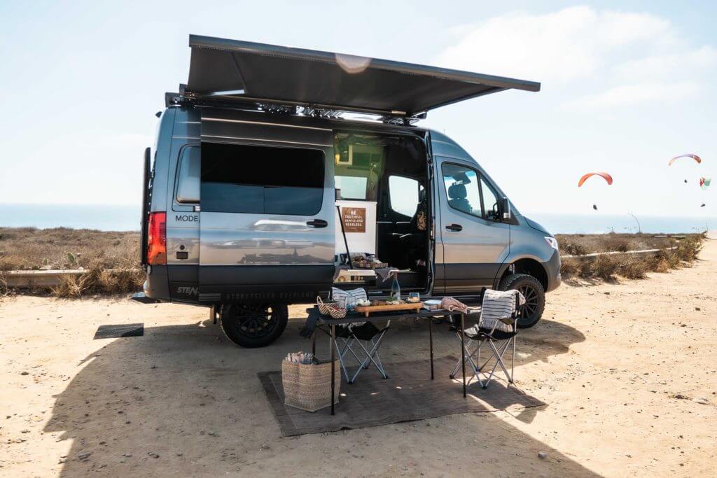 Storyteller Overland Mode rental with awning extended and hang gliders in the background